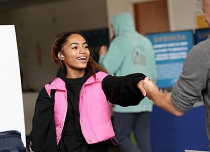 Hartwick College student shaking hands with professional during Industry Days event